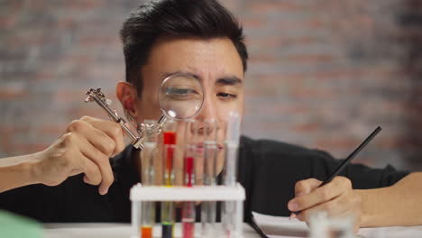 doubting man looks at materials sample doing tests in lab