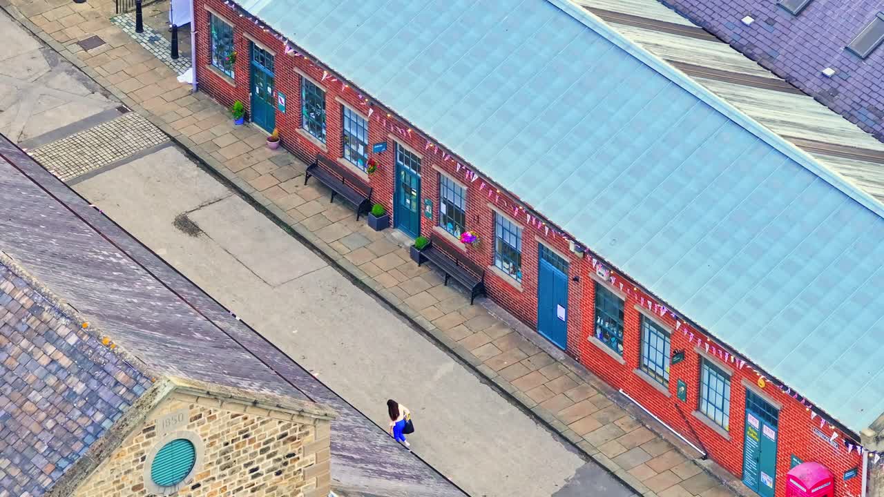 Drone view of restored Victorian workshop at Elsecar Heritage Centre, showing brick architecture and courtyard layout, located in Barnsley, South Yorkshire, England