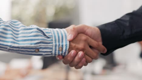 close-up of two male hands in the middle of a corporate office in the background, they are shaking hands firmly, greeting, saying goodbye, getting acquainted, congratulating, pride, joy