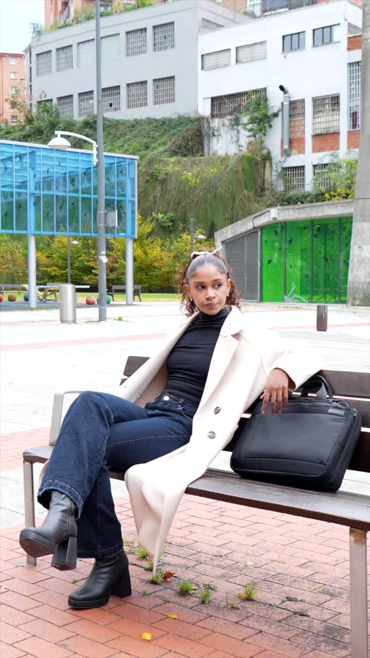 Woman with a handbag in an urban park