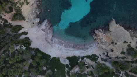 Drone-top-view-of-Cala-d'egos-beach-with-turquoise-water,-Spain