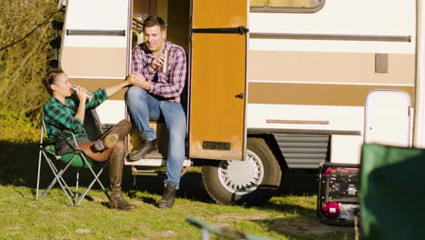 boyfriend sitting on the stairs of camper van