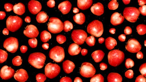 las manzanas rojas rotan sobre un fondo negro