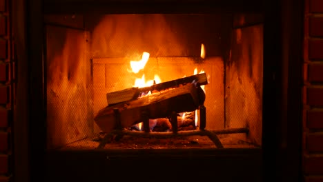 fire in brick fireplace, firewood burning, wood blazing in cozy lodge or cabin.