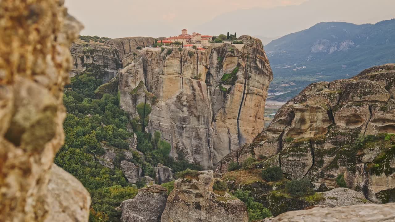 Greek monastery on mountain top cliff face Meteora