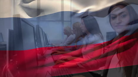 animation of flag of russia over happy caucasian female colleagues working at computers