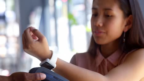 teenage girl making payment through smartwatch 4k