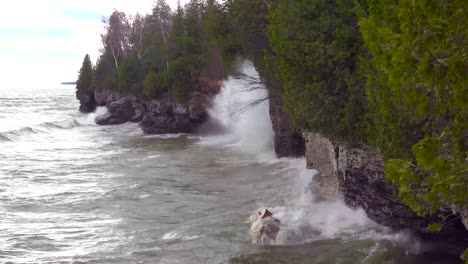 waves pound against the beautiful coastline of the great lakes in door county wisconsin