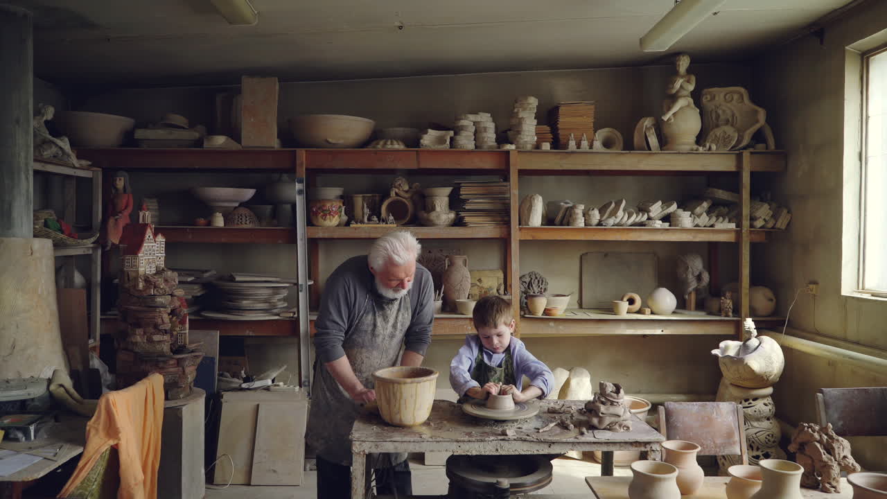 Grandfather and grandson working with clay in a pottery studio