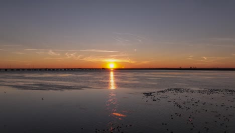 reverse reveal of sunset over marsh near mobile bay, alabama