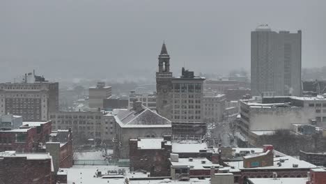 worcester’s t and g tower stands near city hall. stone facade dominates the downtown block. overhead vantage frames the urban skyline, aerial.