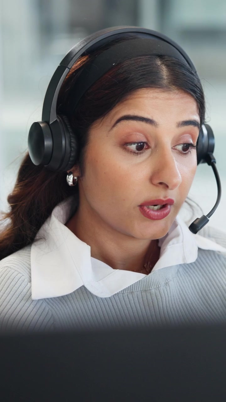 Customer Service Representative Talking on Headset in Office