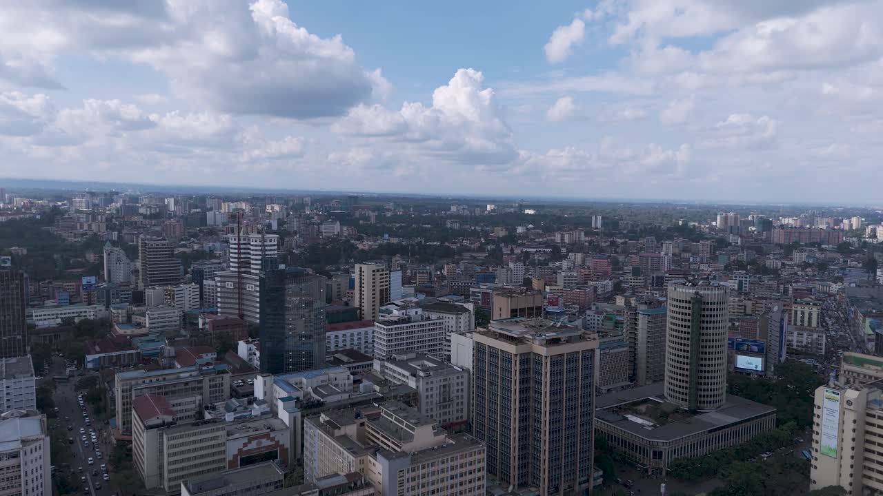 A beautiful aerial drone footage of the CBD of Nairobi, Kenya, showcasing urban office spaces, modern residential areas, the Nairobi Expressway, and Waiyaki Way. Captured during the day