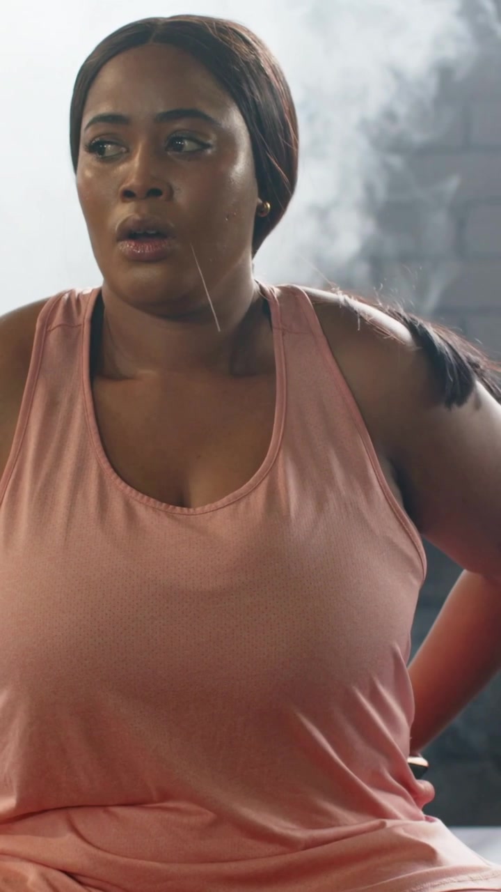 Vertical video: Adjusting pink tank, woman catching breath after finishing set on bench, fog