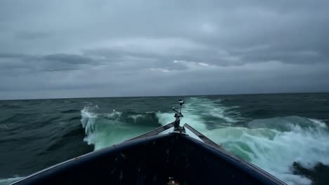 boat sailing through rough waves in a stormy ocean