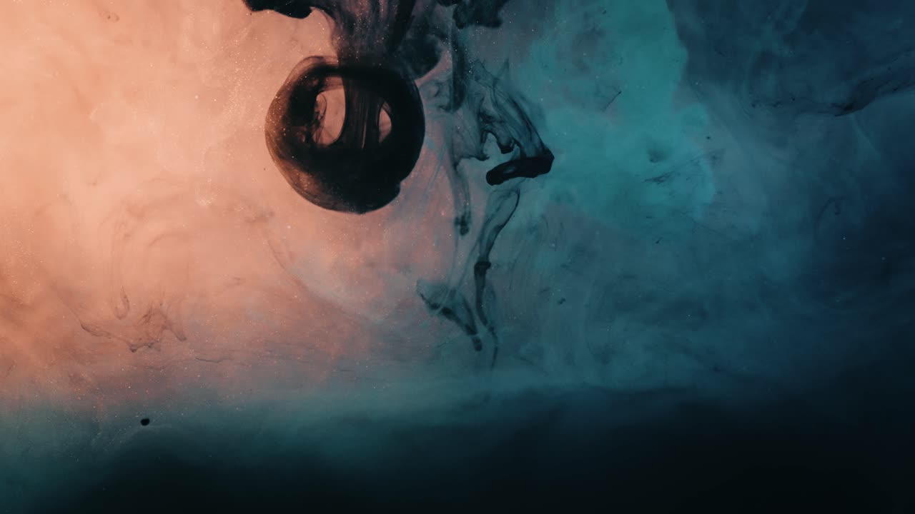 Slow Motion Of Colorful Paint Bursting In Water Creating Patterns