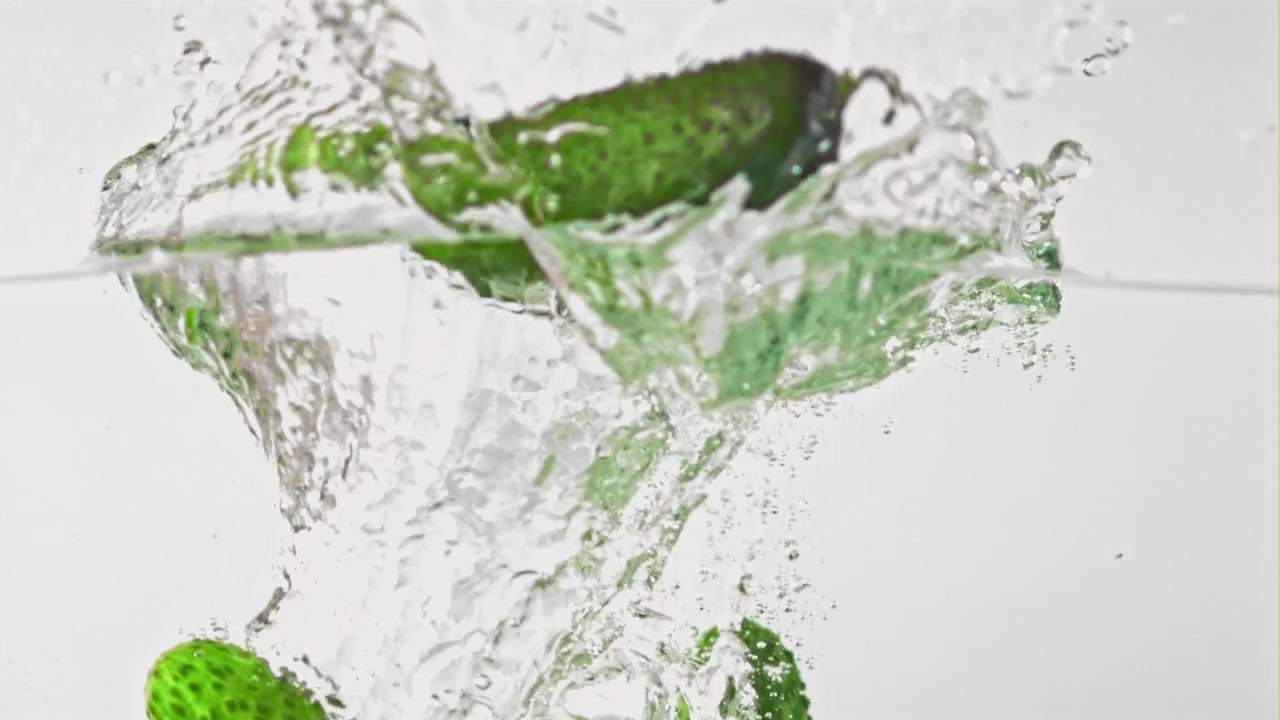 Cetriolo verde fresco che si tuffa in acqua limpida