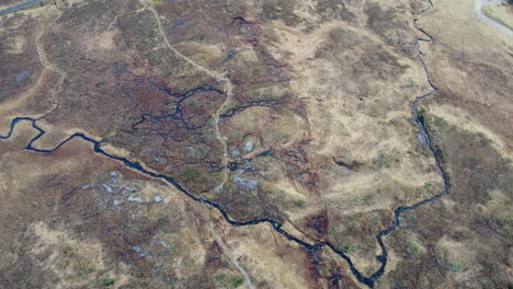 aerial shot of the rivers and streams of the hills and mountains at glencoe, scotland in great britain