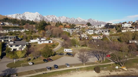 new zealand caravan marina sailboat park lake wakatipu wanaka queenstown south island spring aerial cinematic drone flight franktown blue sky sunny beautiful day backward movement