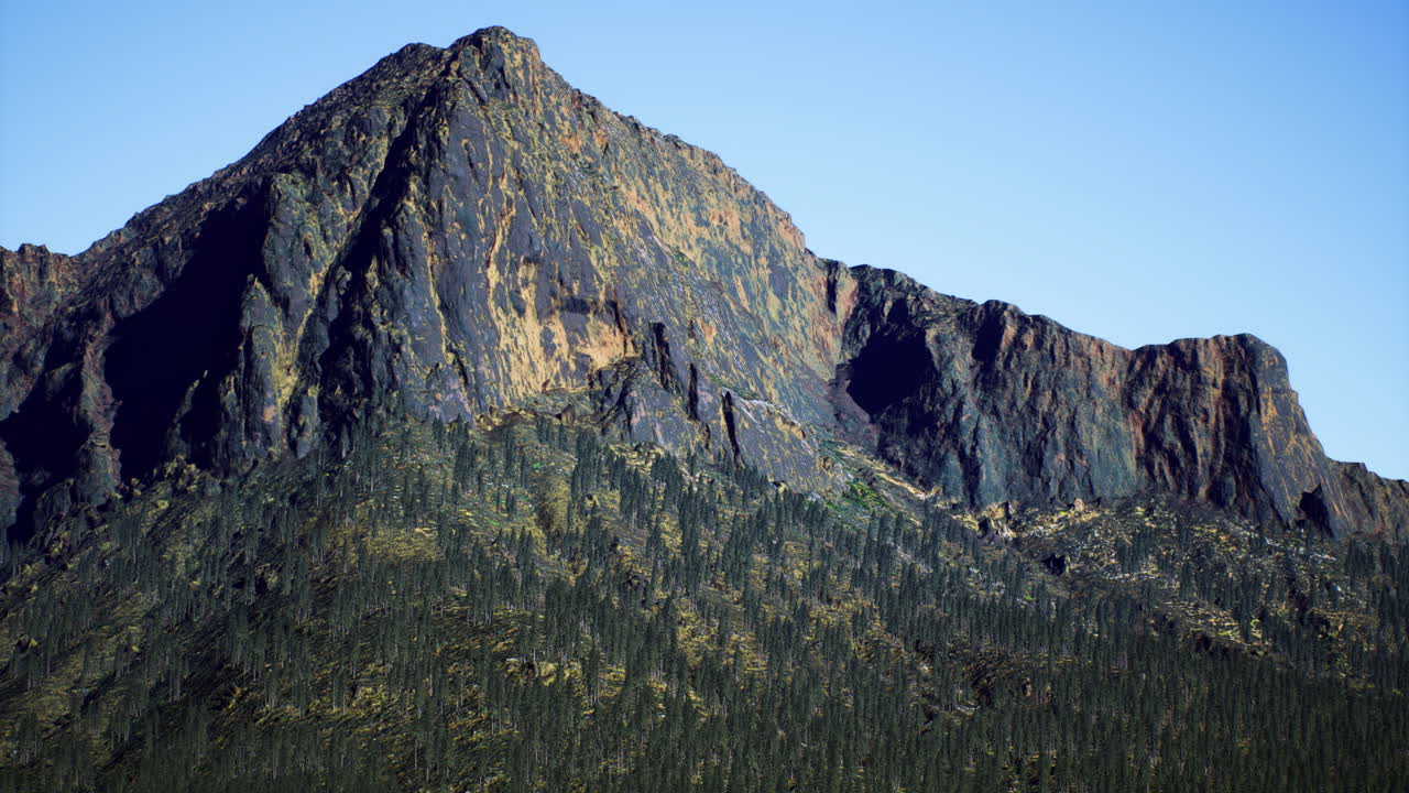 Mountain peak stands tall against a clear blue sky showcasing nature