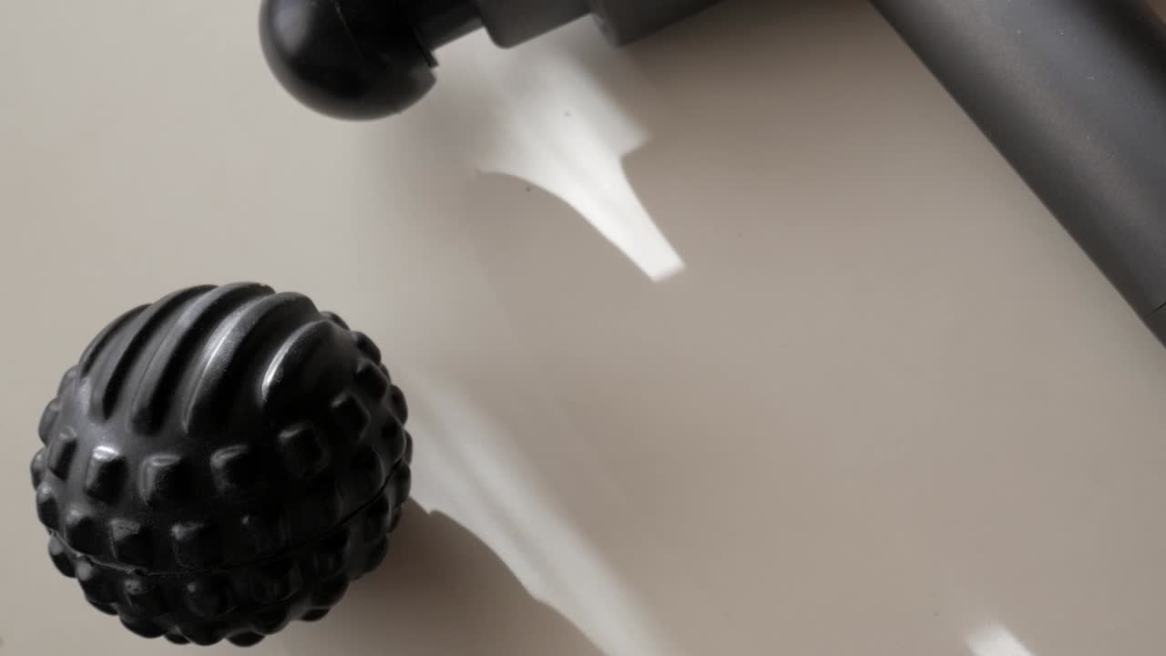 Close-up of a black massage ball with textured surface, perfect for muscle relaxation