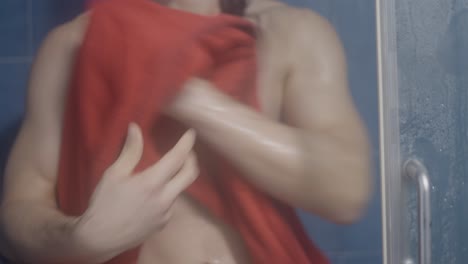 man drying himself in a shower