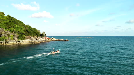 A-boat-passing-by-with-partial-view-of-a-hill-and-jungle