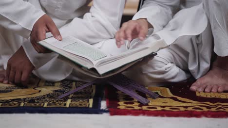 muslim people reading quran book at home