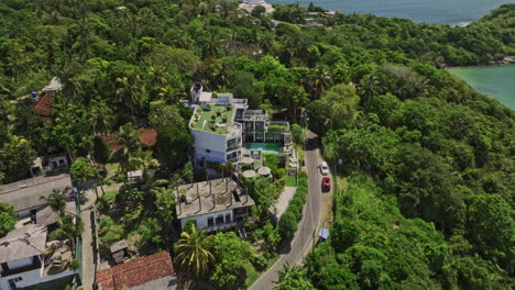 Unawatuna-Sri-Lanka-Aerial-v13-birds-eye-view-fly-around-hotel-on-Rumassala-hills-capturing-panoramic-views-of-jungle-beach,-hillside-bay-and-ocean-on-a-sunny-day---Shot-with-Mavic-3-Cine---April-2023