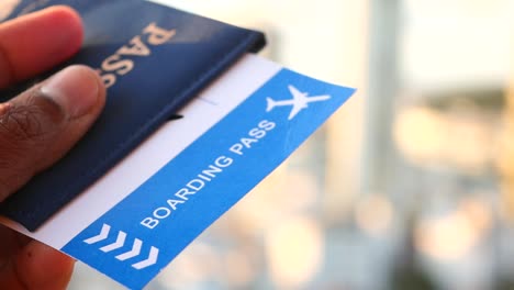 person holding a passport and boarding pass