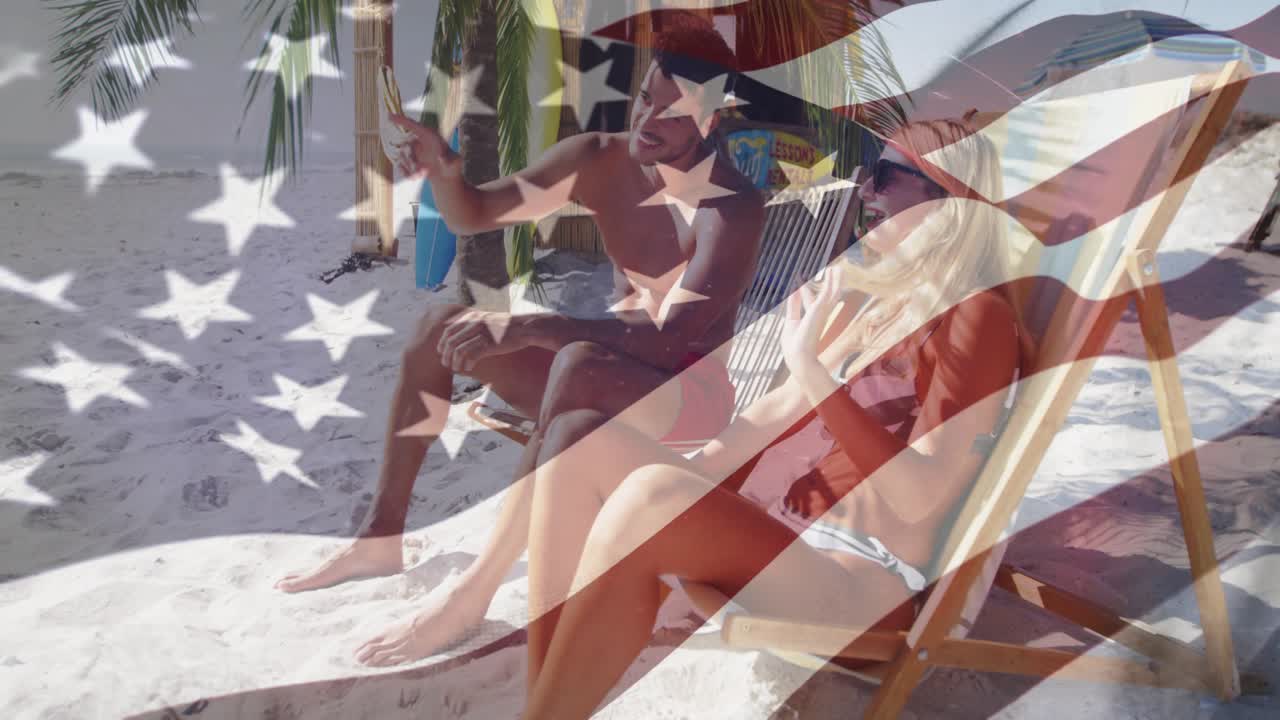 Man pointing, woman adjusting shades and turning, beach, faint US flag overlay for travel