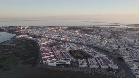 Aerial-view-of-waterfront-buildings-in-Isla-Cristina-By-the-Atlantic-Ocean,-Orbiting-shot