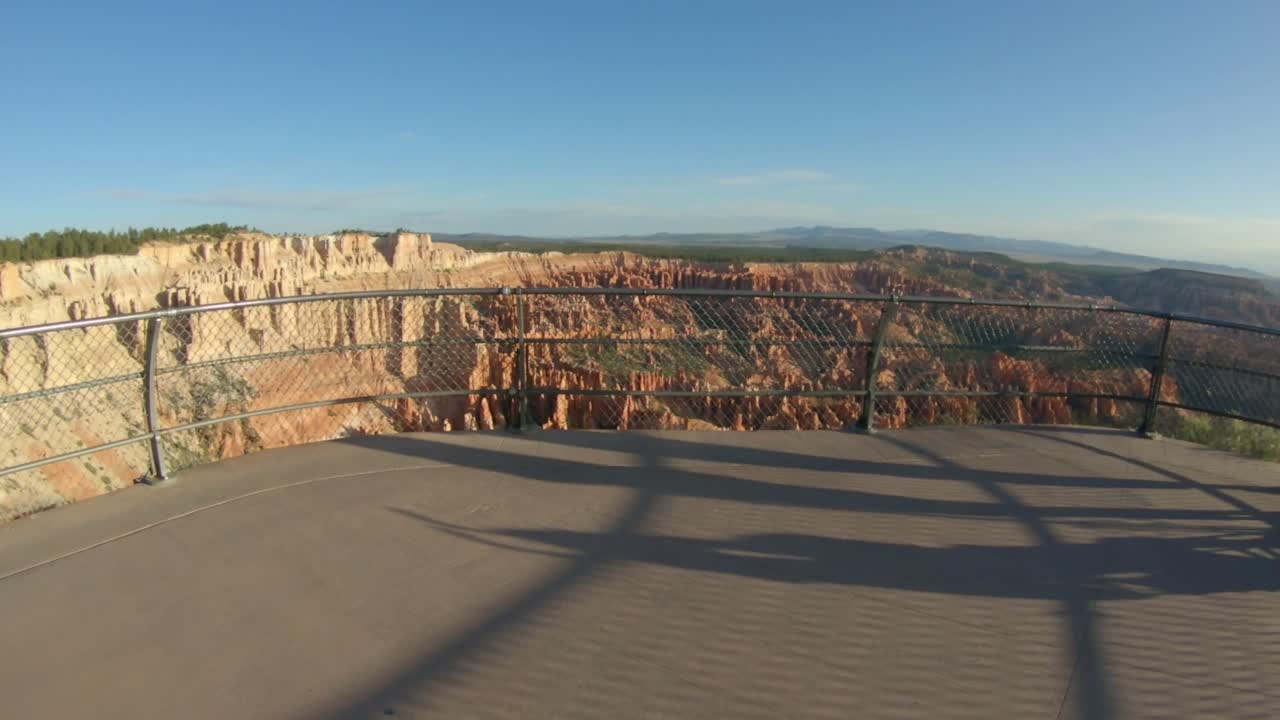 Walking to the edge of Bryce Point Overlook and pointing into the the canyon.