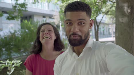 Cheerful-couple-looking-at-camera-and-laughing.