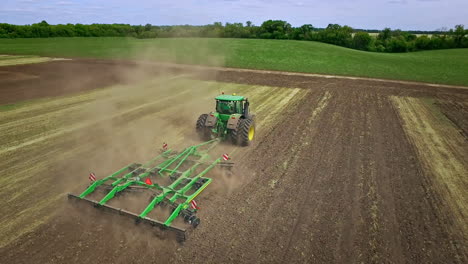 Farming-tractor-with-trailer-for-ploughing-plowing-on-agricultural-field