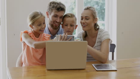 Portrait-of-happy-family-using-technology