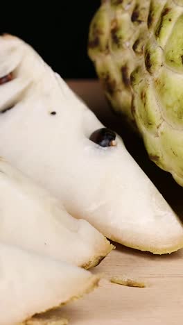 custard apple and slices displayed on a table