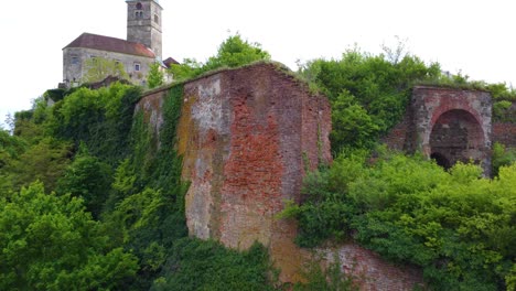 tall imposing red brick wall at the top of hill outside gussing castle