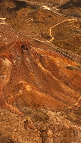 flying above the hot desert divided by highway. mojave desert from aerial view in california, usa. vertical video