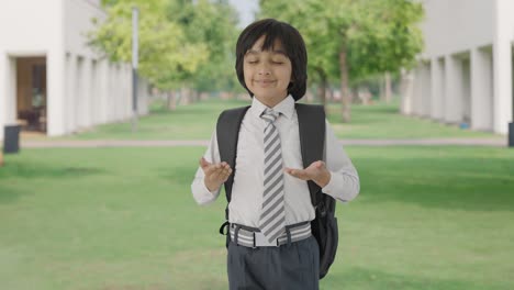 Happy-Indian-school-boy-doing-breathe-in-breathe-out-exercise