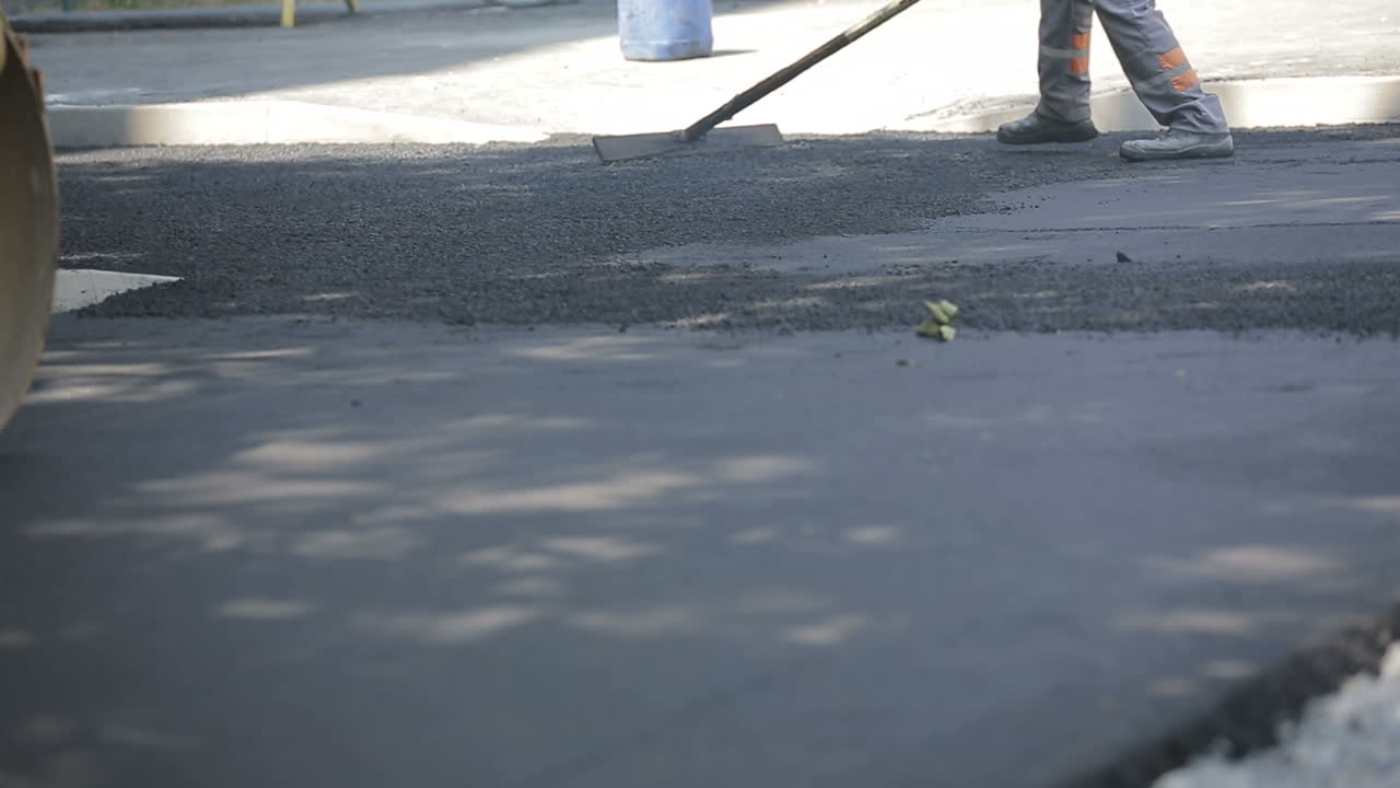 Road Construction Works. Road construction works with steamroller machine