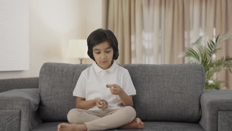 Happy-Indian-boy-counting-money-coins