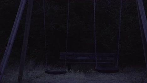 spooky scary swing set moving in the dark, 4k, uhd, zoutelande, zeeland, netherlands, holland, 4k, uhd