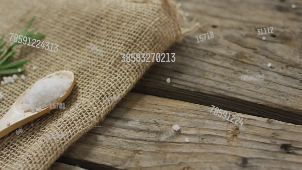 Numeric codes drifting from right starting camera panning zooming focusing salt spoon and rosemary