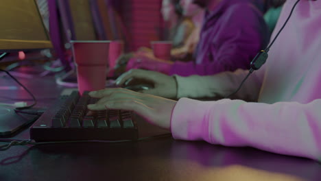 close up of a female gamer's hand on keyboard playing virtual video games