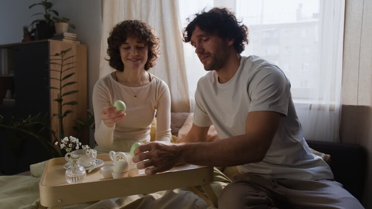 Couple celebrating Easter breakfast in bed