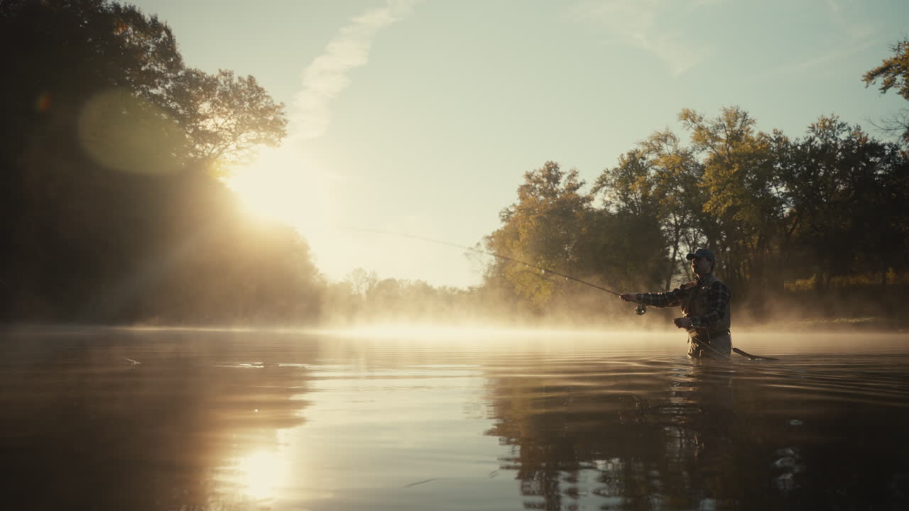 Man Fly Fishing in Misty Morning Light
