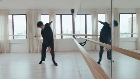 Young Man Practicing Contemporary Dance in front of Mirror at Studio