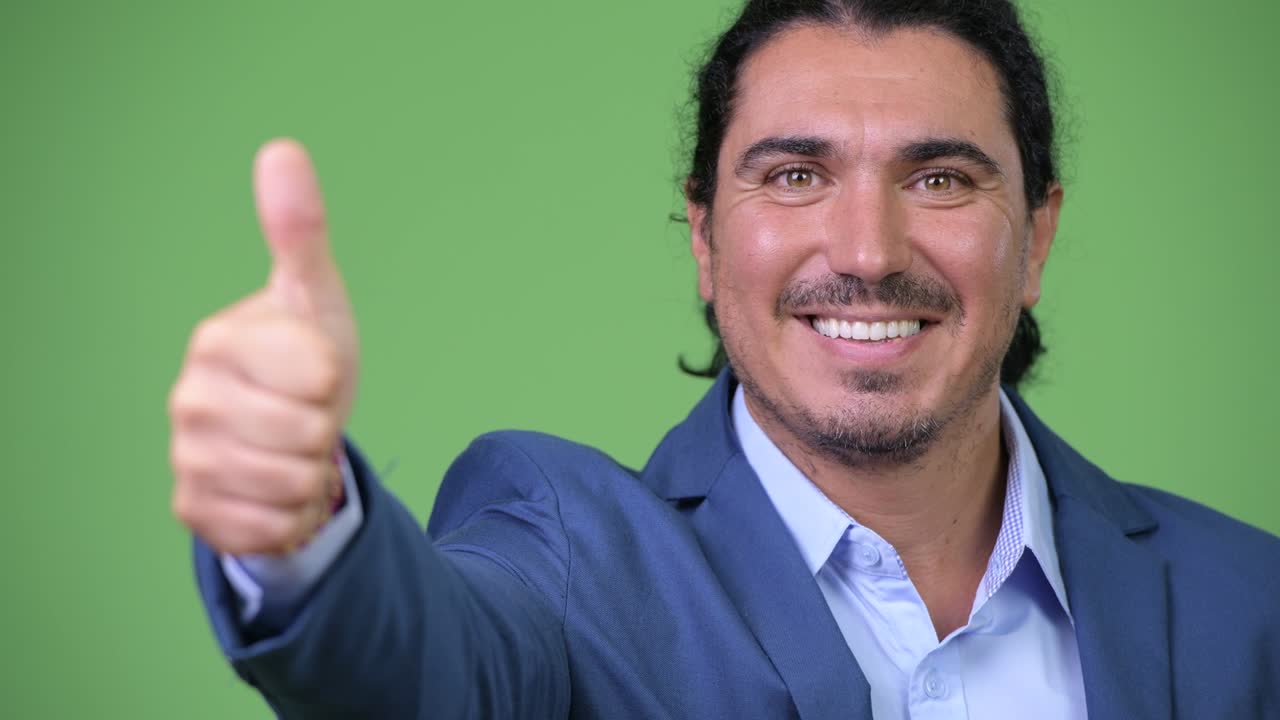 Handsome businessman giving thumbs up