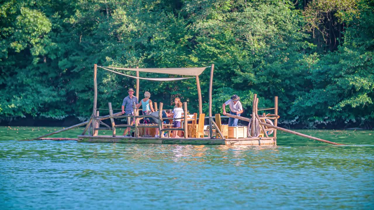 Family bonding on a log Hlodovc raft in Muta, Slovenia